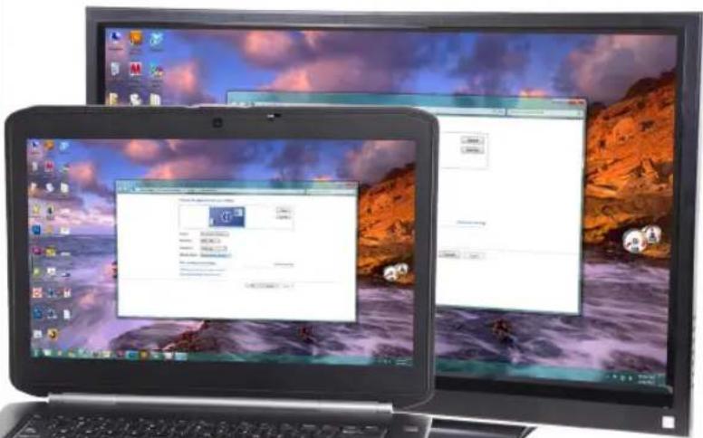 Desktop setup showing two laptops with a system dialog open, one displaying a file named '10.00' and the other displaying a logo.