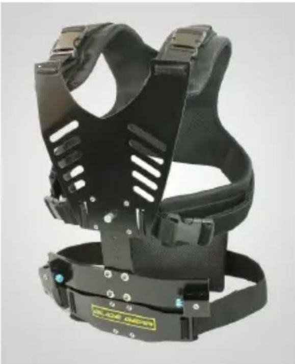 Black athletic helmet with attached straps and a small green badge (no visible text or symbols)