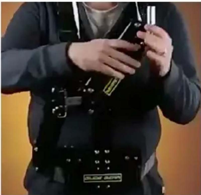 Person wearing a black SLICE BEAR device with a handheld device, standing against a plain background (no visible text or symbols)
