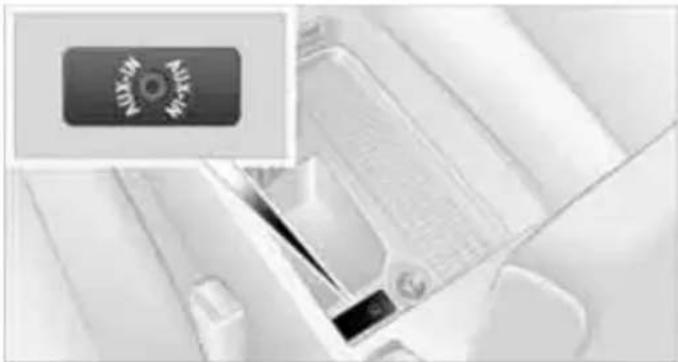 Close-up of a white mechanical component with a small inset showing a circular emblem (no readable text or symbols)