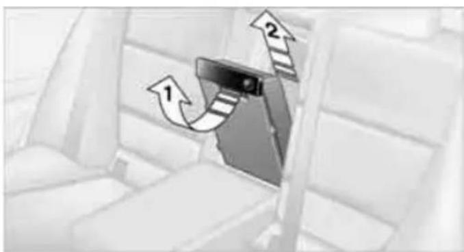 Interior view of a vehicle seatbelt with directional arrows indicating movement (no text or symbols)