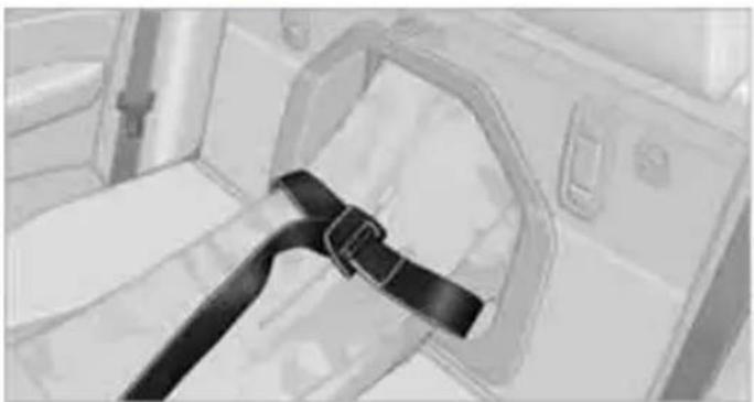 Interior view of a vehicle showing a black belt buckle and seatbelt (no text or symbols visible)