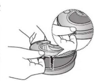 Illustration of hands assembling a circular mechanical component (no text or symbols visible)