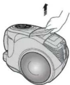Illustration of a hand pressing down on a small vacuum cleaner's air vent (no text or symbols)