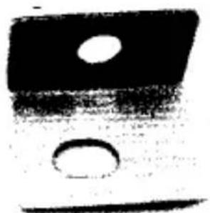 Abstract black-and-white graphic with two circular cutouts (no text or symbols)