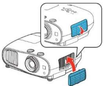Diagram showing a projector with labeled components and directional arrows indicating motion or assembly.