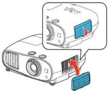 Diagram showing a projector with blue buttons and red arrows indicating action or operation, likely illustrating a camera or projector mechanism.
