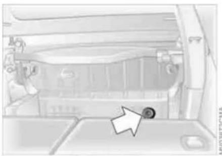 Interior view of a vehicle showing a car trunk and dashboard with a highlighted circular component (no text or symbols visible)
