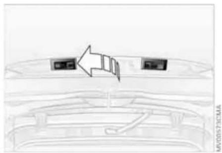 Top-down view of a car dashboard with two rear seats and an arrow pointing to the left side (no text or symbols)