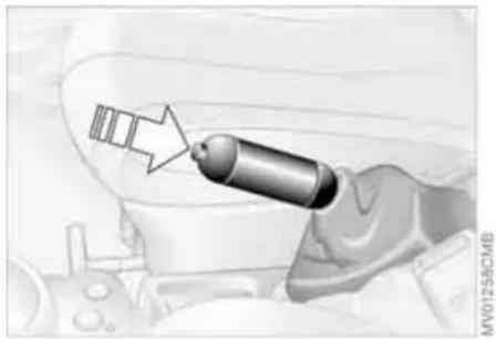 Illustration of a hand holding a missile with an arrow pointing to it, against a vehicle background (no text or symbols)