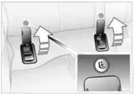 Diagram showing car seatbelt adjustment with upward arrows and a circular logo, likely illustrating seatbelt replacement or repair instructions.