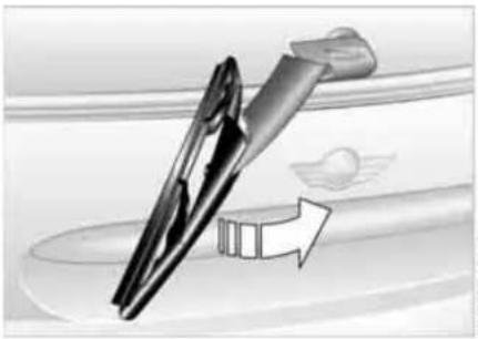Illustration of a mechanical tool interacting with a curved surface, showing motion direction (no text or symbols)