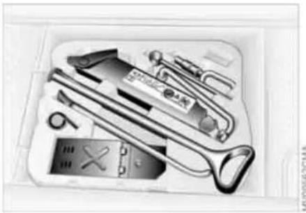 Open toolbox containing various office supplies including pens, tools, and a computer (no visible text or labels)