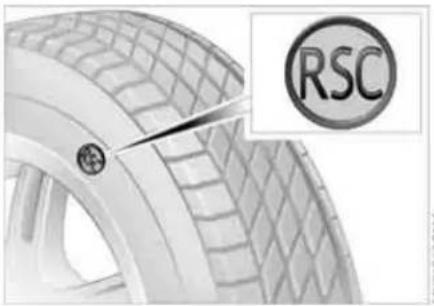 Close-up of a car tire with visible tread pattern and a circular RSC logo (no text or symbols on the tire itself)
