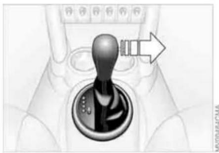 Mechanical gear shift lever mechanism with arrow indicating direction (no text or symbols)