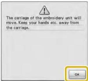The carriage of the embroidery unit will move. Keep your hands etc. away from the carriage.