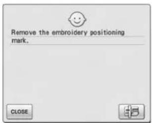 Remove the embroidery positioning mark.
