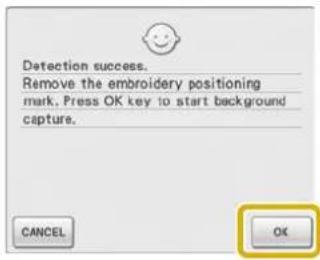 Detection success. Remove the embroidery positioning mark. Press OK key to start background capture.