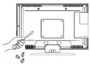 Line drawing of a hand holding a pen next to a computer monitor with coins nearby (no text or symbols)