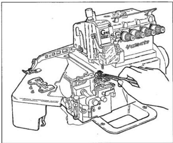 Line drawing of a sewing machine with hands operating it (no text or symbols visible)