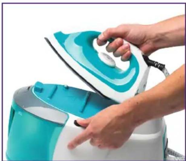 Close-up of hands ironing a turquoise and white steam iron (no text or symbols visible)