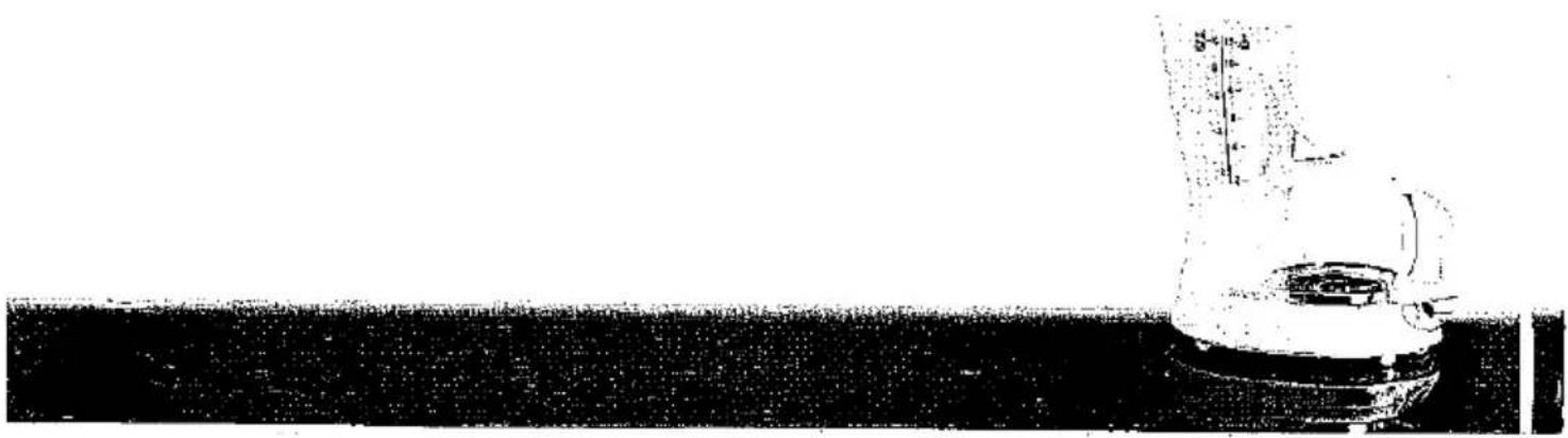 Black-and-white photo of a laboratory flask with a graduated cylinder on top, no visible text or symbols