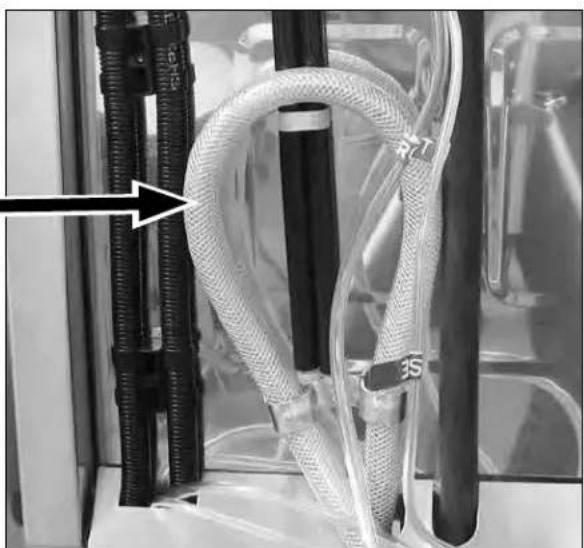 Close-up of a medical or laboratory setup with coiled tubing and connectors, no visible text or symbols