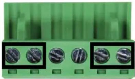 Close-up of green electronic components with five circular metallic parts, no visible text or symbols
