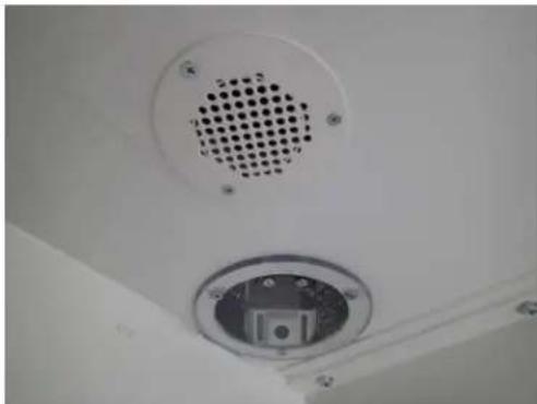 Close-up of a ceiling-mounted air vent with a circular vent and central socket (no text or symbols visible)