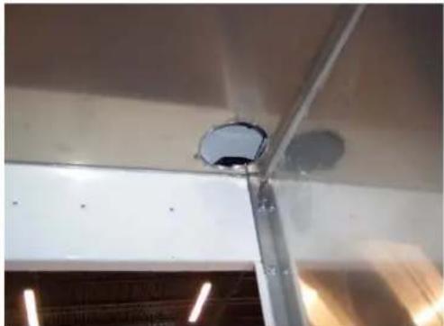 Interior ceiling view showing a mounted fixture with a circular component and light fixtures (no visible text or symbols)