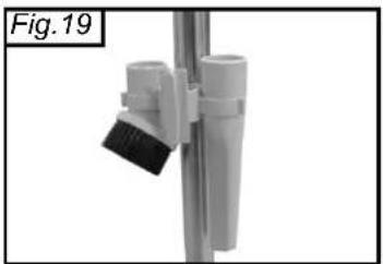Close-up of a white spray bottle with black bristles mounted on a vertical pole, labeled Fig. 19 (no text or symbols on the object itself)