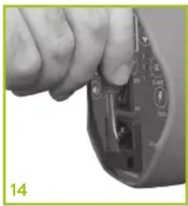 Close-up of a hand inserting a device into a terminal block (no visible text or symbols)