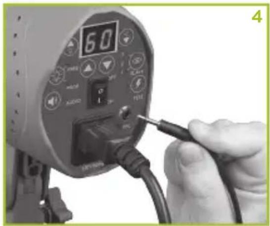 Close-up of a handheld electronic device with a digital display and cable, no visible text or symbols on the device itself.