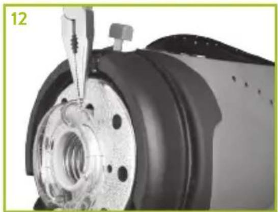Close-up of a mechanical component with a tool inserted, showing internal components and a circular base (no visible text or symbols)