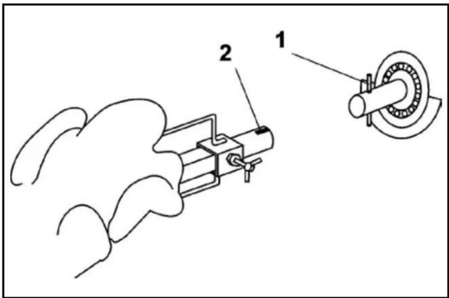 Technical diagram showing a mechanical assembly with labeled components 1 and 2, including a cylindrical component and a curved pipe.