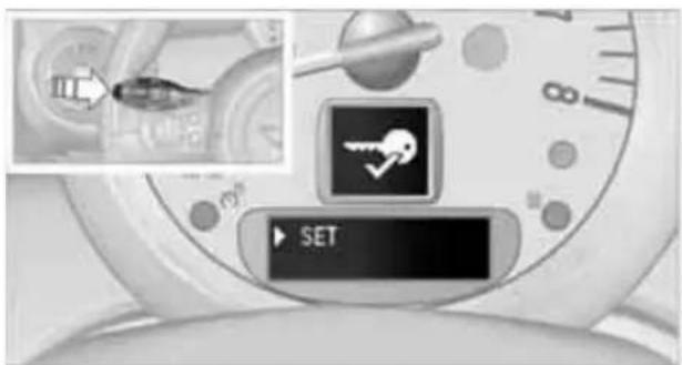 Close-up of a smartwatch control interface showing a key set and SET button, with an inset image of a device.
