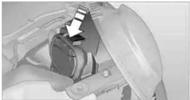 Close-up of a mechanical component with a white arrow pointing to a component (no visible text or symbols)