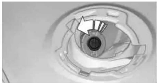 Close-up of a circular mechanical component with internal features and a white arrow indicating direction (no text or symbols)