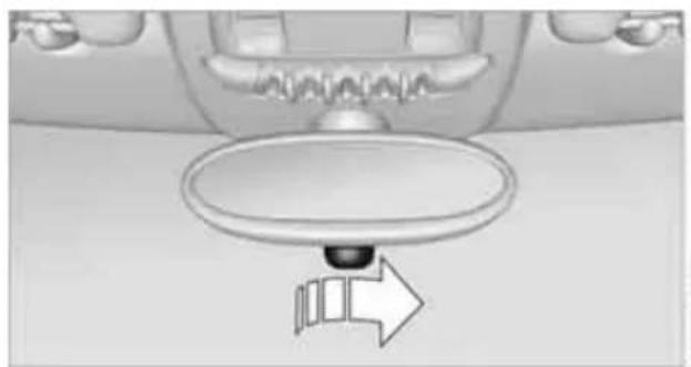 Top-down view of a car dashboard with a circular dial and directional arrow (no text or symbols)