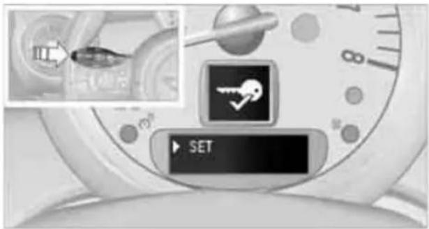 Close-up of a smartwatch control interface showing a key set and SET button with an inset image of a device.