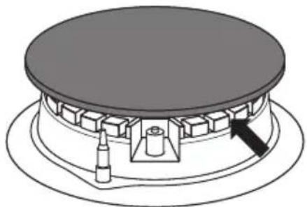 Technical diagram of a mechanical assembly with a central circular component and a base plate (no text or symbols)