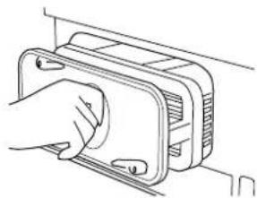 Line drawing of a hand inserting a component into a device housing (no text or symbols)