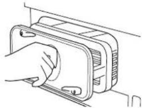Line drawing of a hand inserting a component into a device housing (no text or symbols)