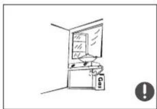 Simple line drawing of a room with a monitor and equipment, no text or symbols present