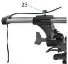Mechanical device with labeled part '23' and cable, no readable text or symbols beyond label