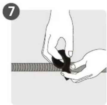 Illustration of hands holding a black object with a ruler, no text or symbols present