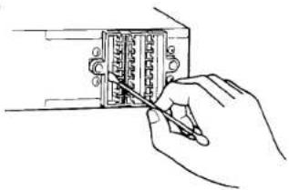 Hand holding a small electronic component with a pen, no visible text or symbols