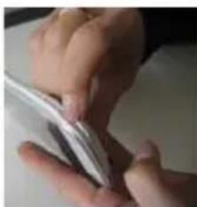Close-up of hands holding a small electronic device (no visible text or symbols)