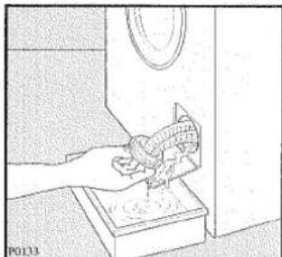Line drawing of a hand washing a small object into a container (no text or symbols)