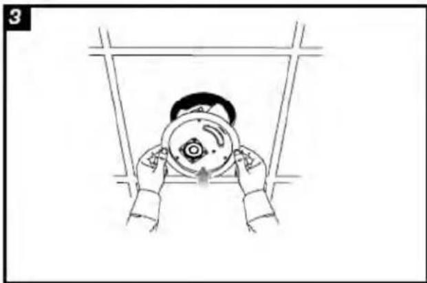 Illustration of two hands holding a circular object above a frame, viewed from above (no text or symbols)